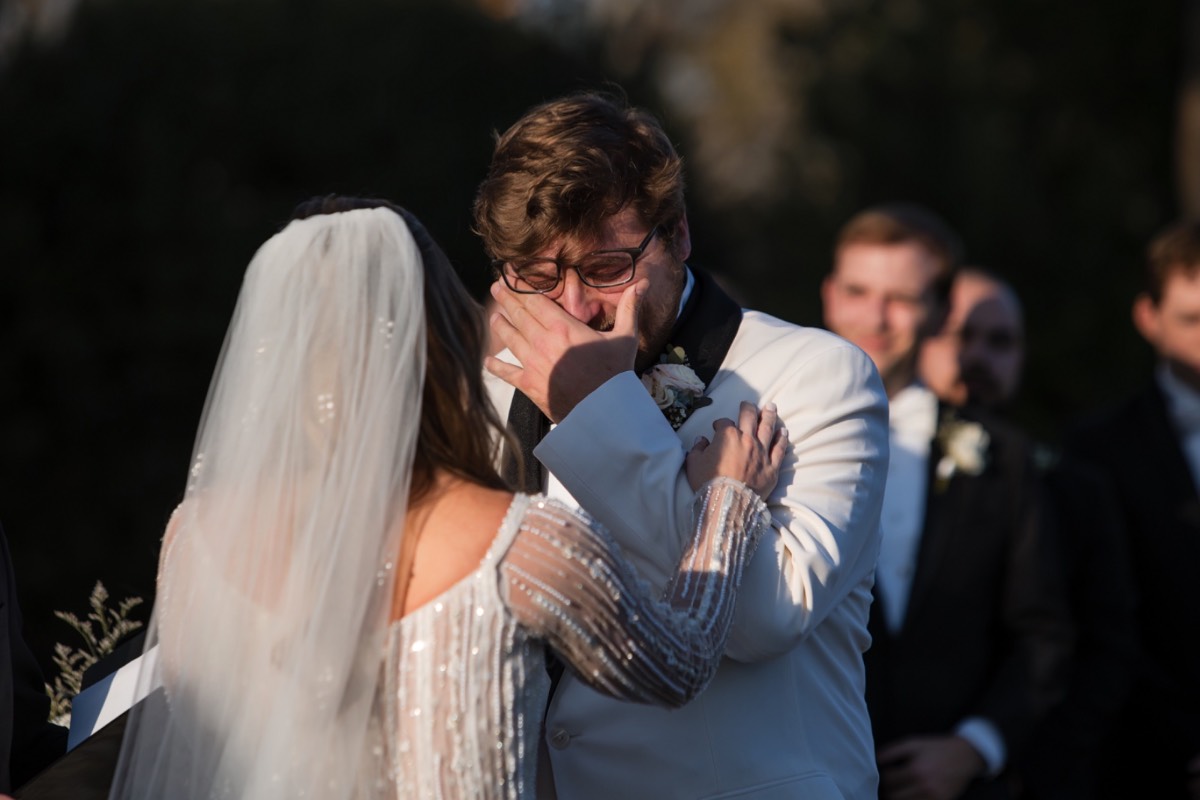 Groom's first view of bride during Barr Mansion Austin ceremony.
