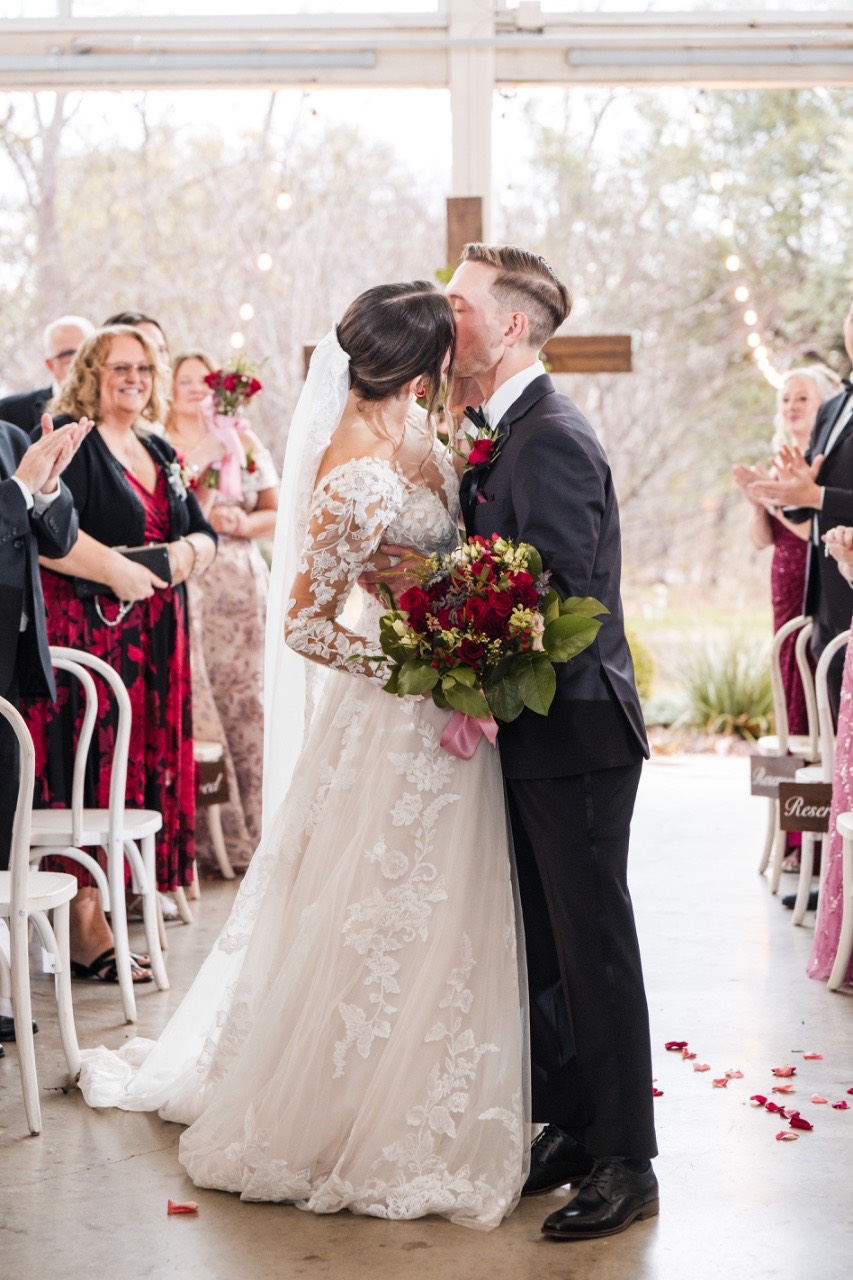 Groom gazing at bride during rainy first look moment.