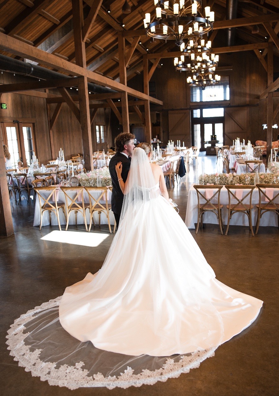 P and B walking hand-in-hand through Hidden River Ranch landscape
