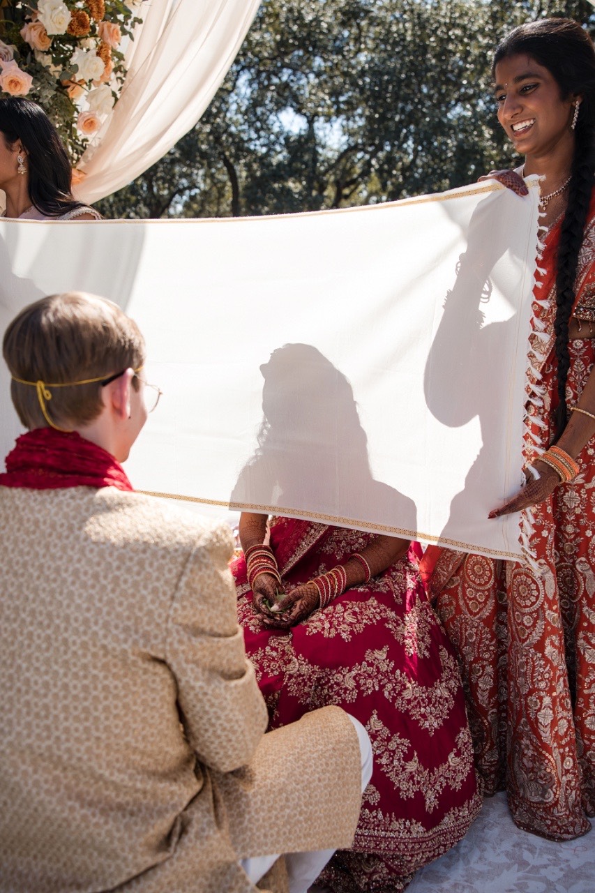Married couple Sreya and Colton exiting ceremony at Texas ranch venue