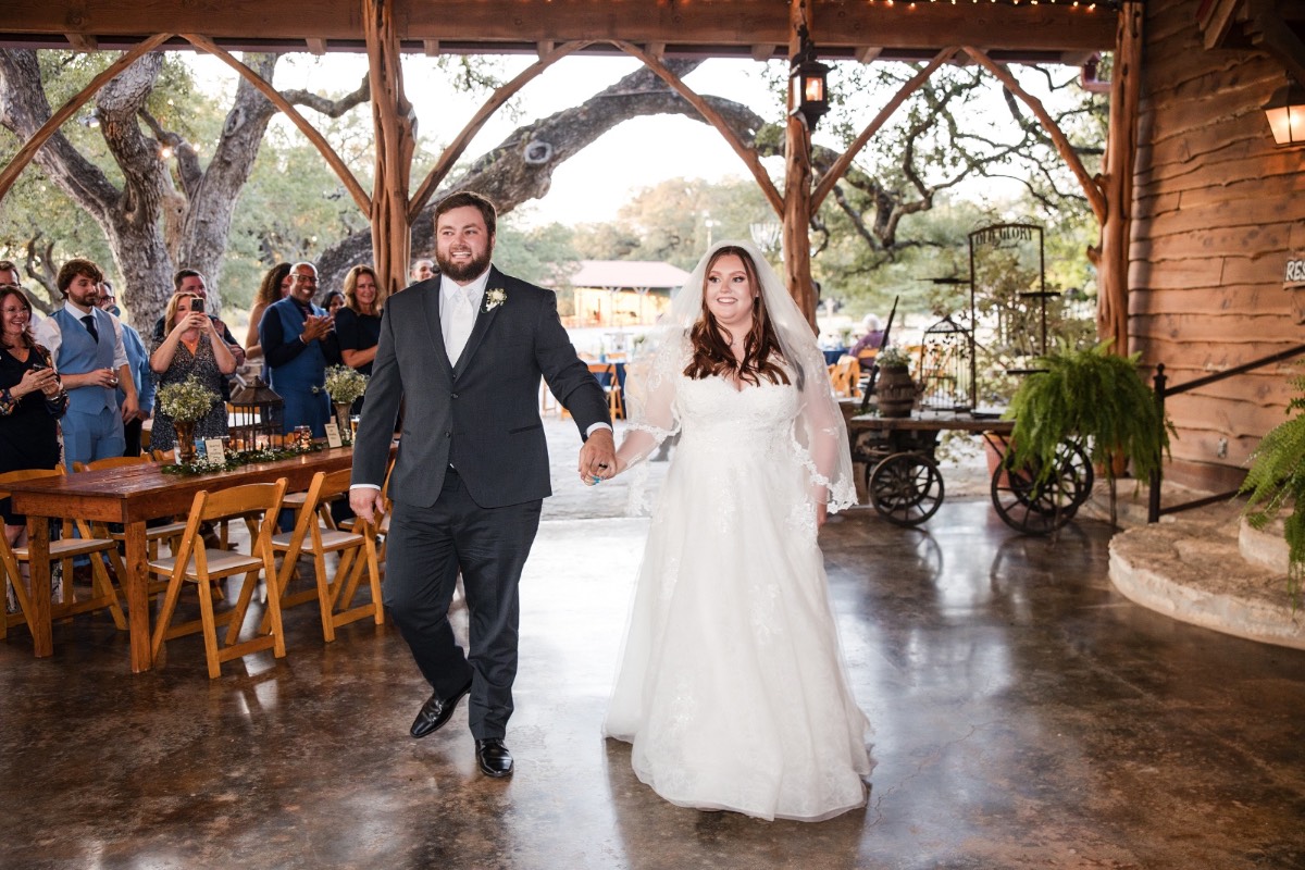Bride with bridesmaids smiling together at Old Glory Ranch Wimberley Texas venue