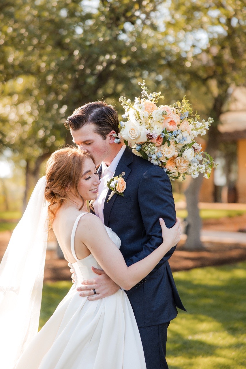 Guests celebrating as newlyweds O and C exit ceremony at Canyonwood Ridge