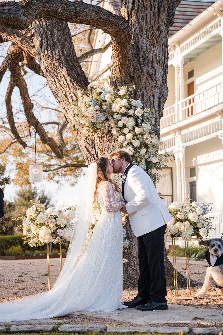 S and A exchanging vows at candlelit Barr Mansion Austin ceremony.