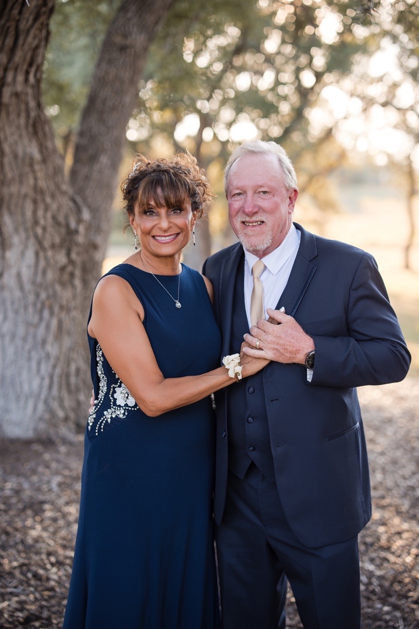 Bride and groom framed by Texas fall foliage at Dripping Springs venue