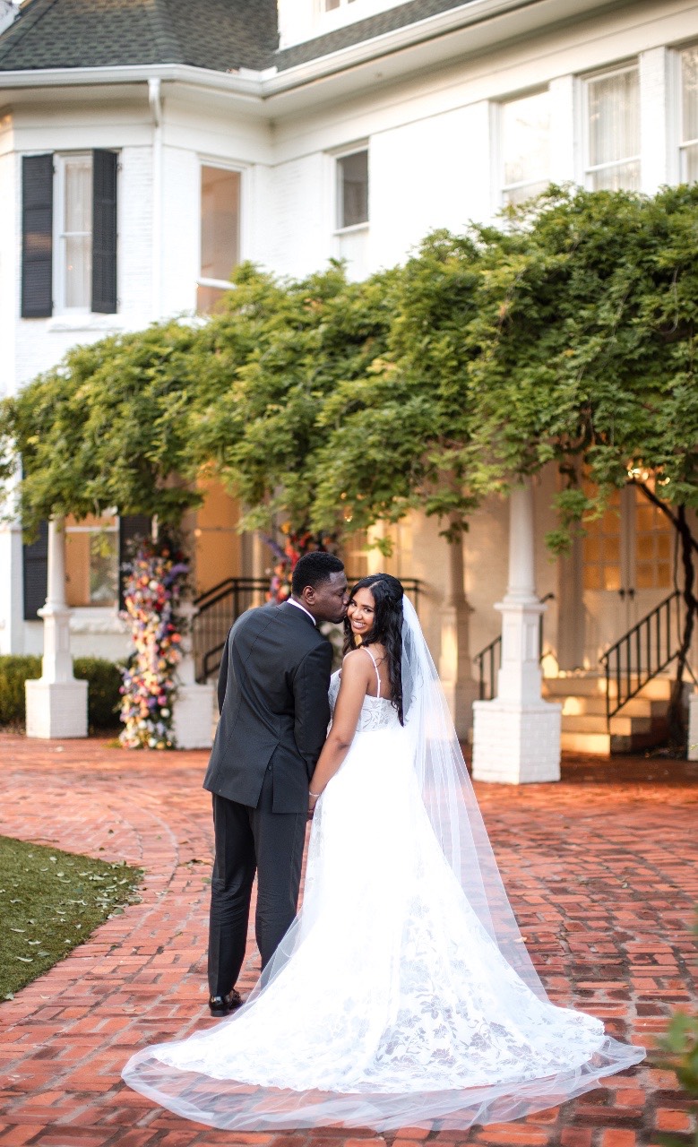 Couple N and H exit ceremony under flower arch Woodbine Mansion