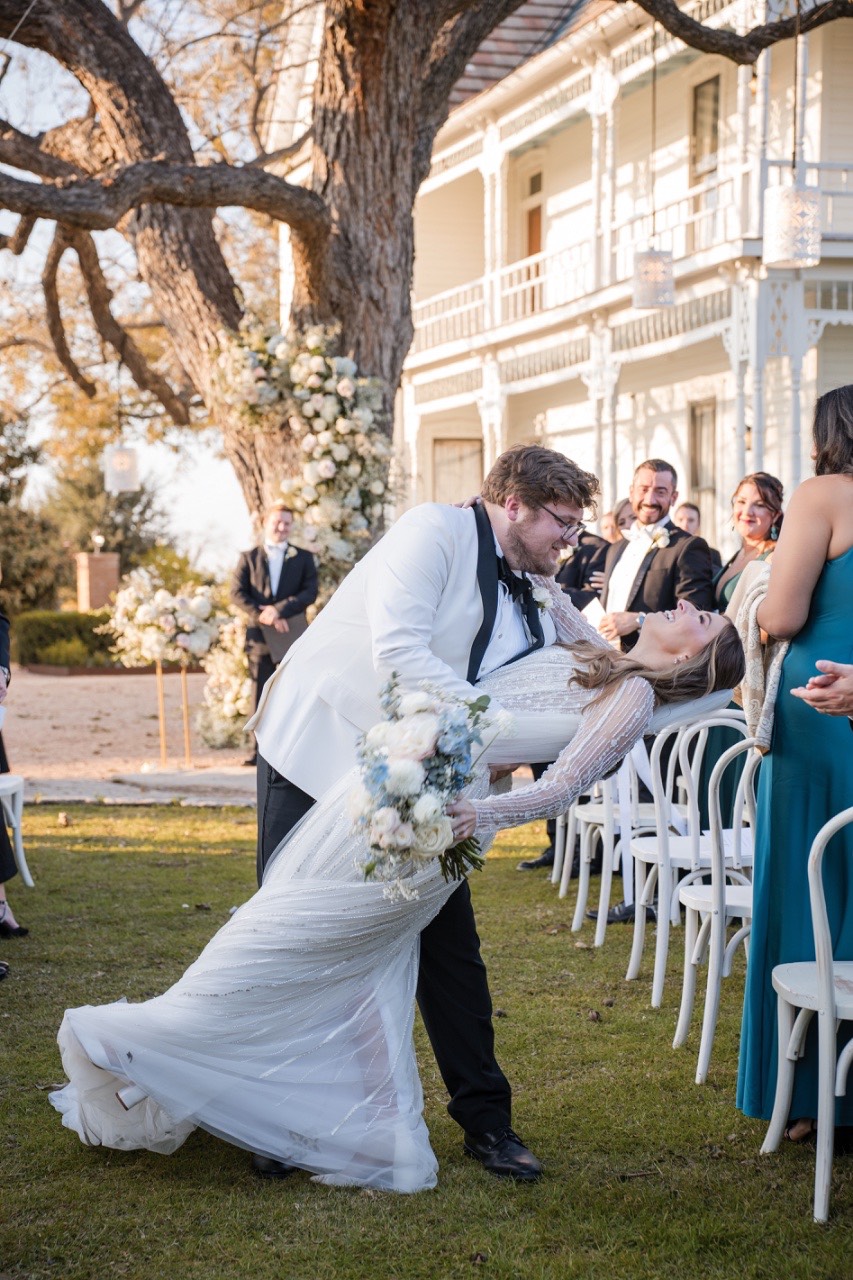 Couple holding hands during wedding vows at Barr Mansion venue.