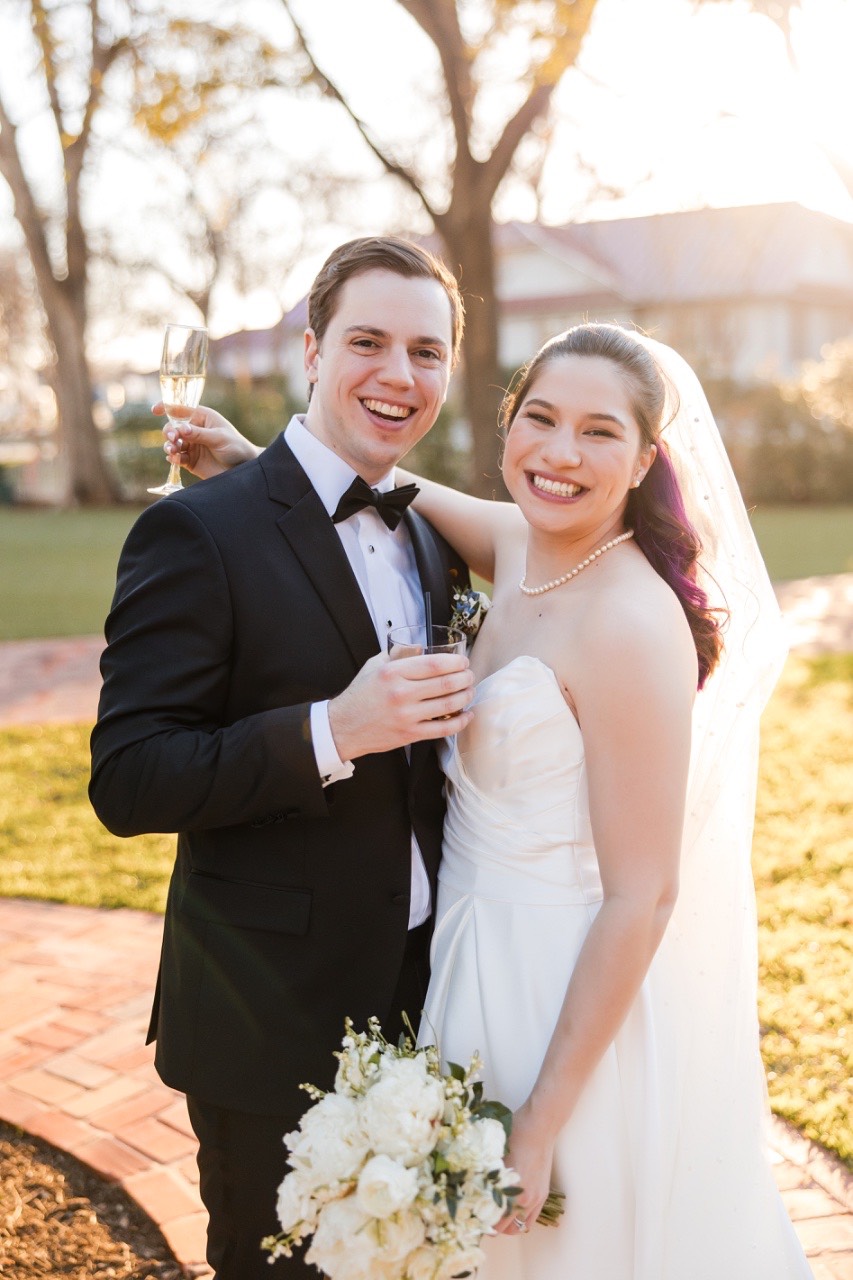 Bride and groom romantic pose outside Woodbine Mansion Round Rock