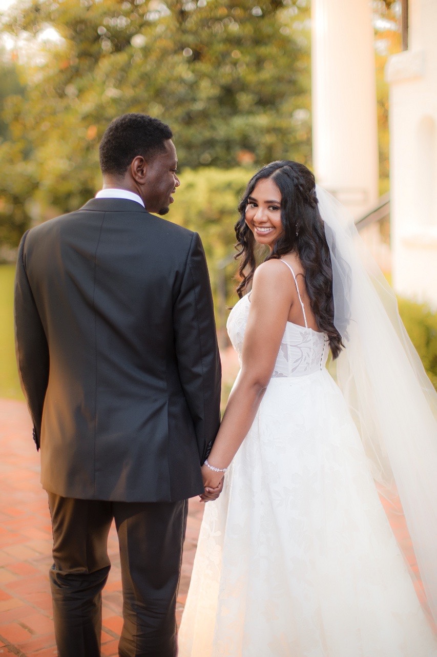 Newlyweds N and H walking together after ceremony at Round Rock