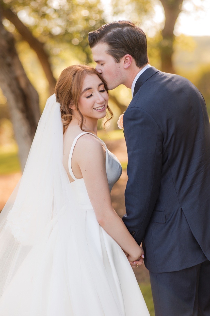 O and C's romantic portrait among Dripping Springs landscape at Canyonwood Ridge