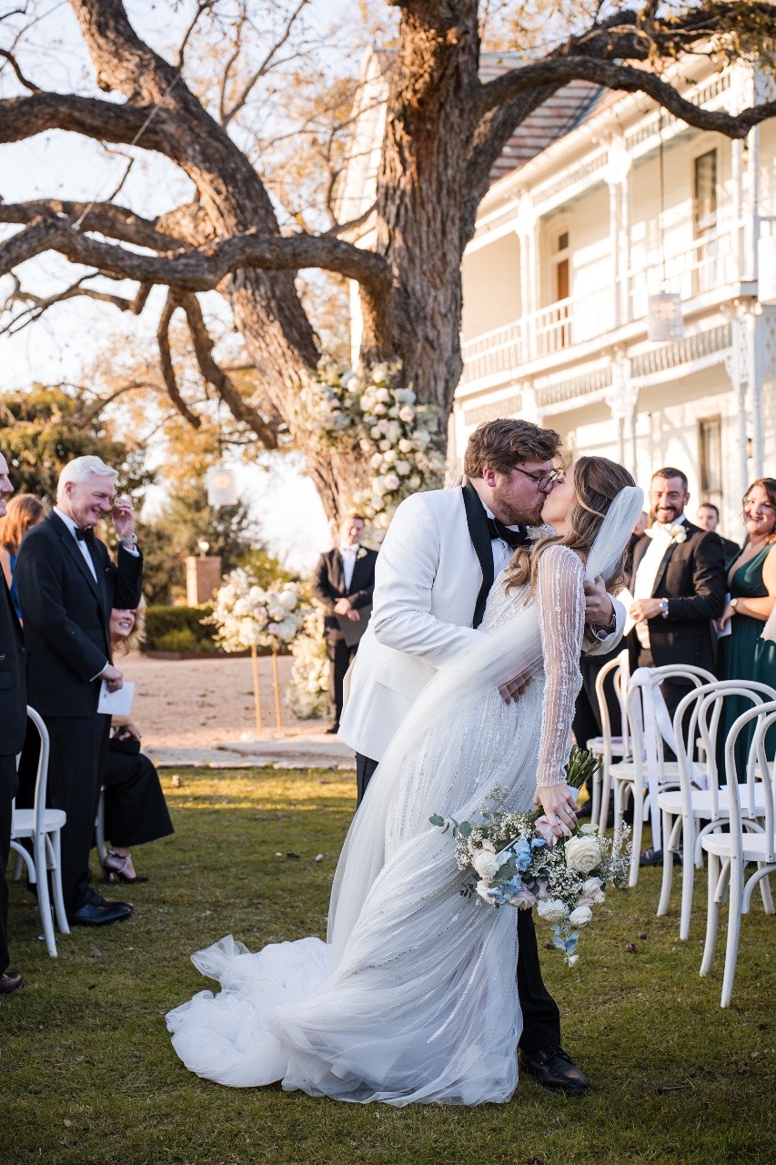 A placing wedding ring on S's finger at Barr Mansion.