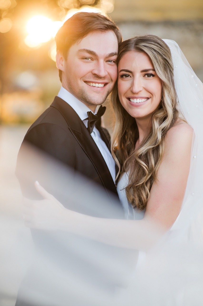 Couple's sweetheart table at Camp Lucy with dramatic floral backdrop