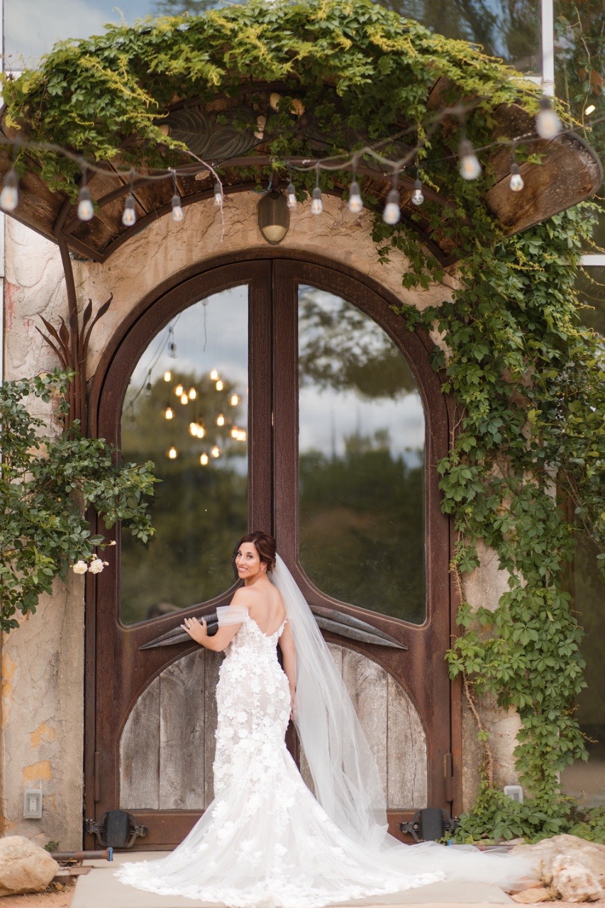 Bride L walking toward groom S for first look at Barr Mansion