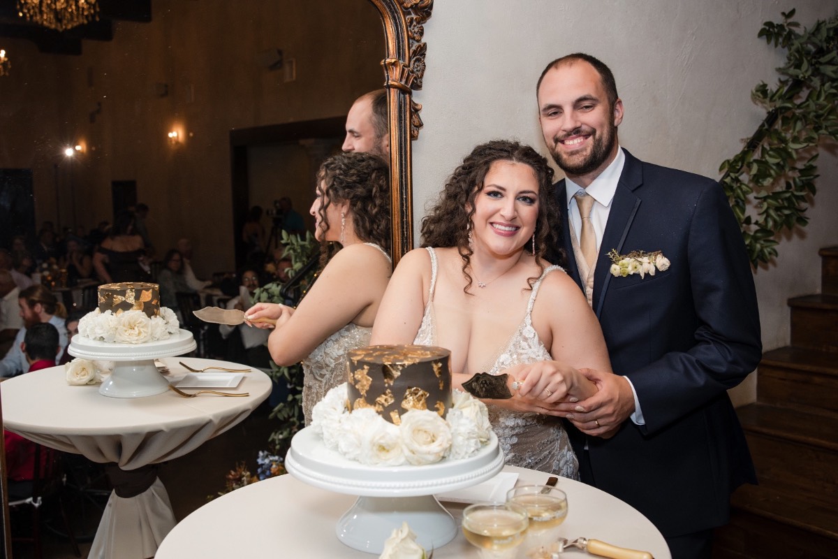 Groom dipping bride during playful portrait moment at Ma Maison Dripping Springs