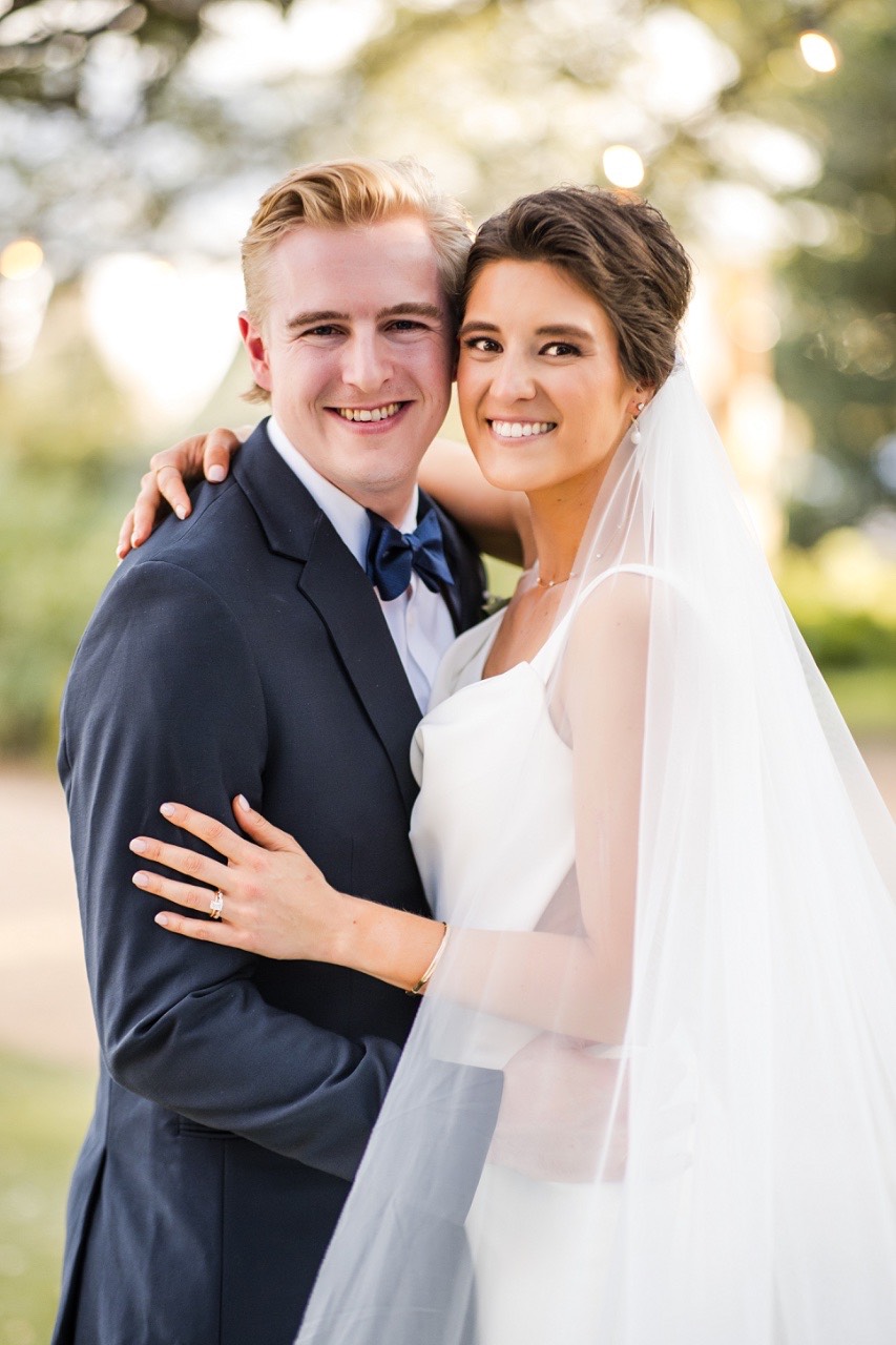 K and N laughing together during formal portraits at Balcones Springs wedding
