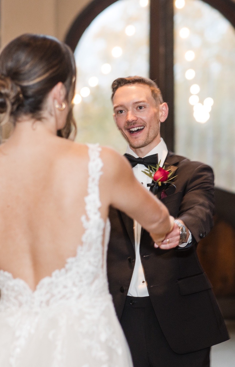 Bride and groom holding hands at altar during ceremony.