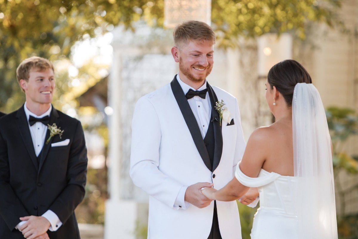 Bride and groom kissing at altar after ceremony at fall Barr Mansion