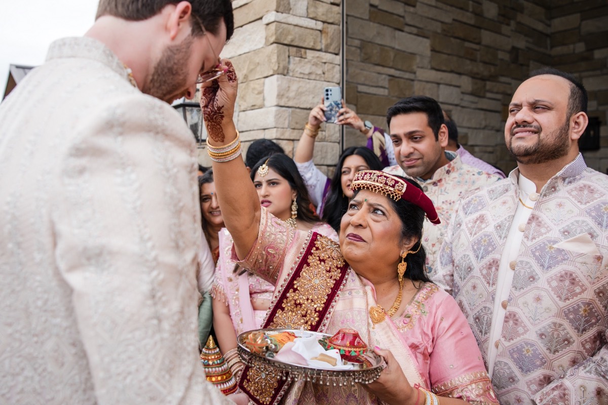 Bride's detailed henna visible during wedding ceremony at Dripping Springs venue
