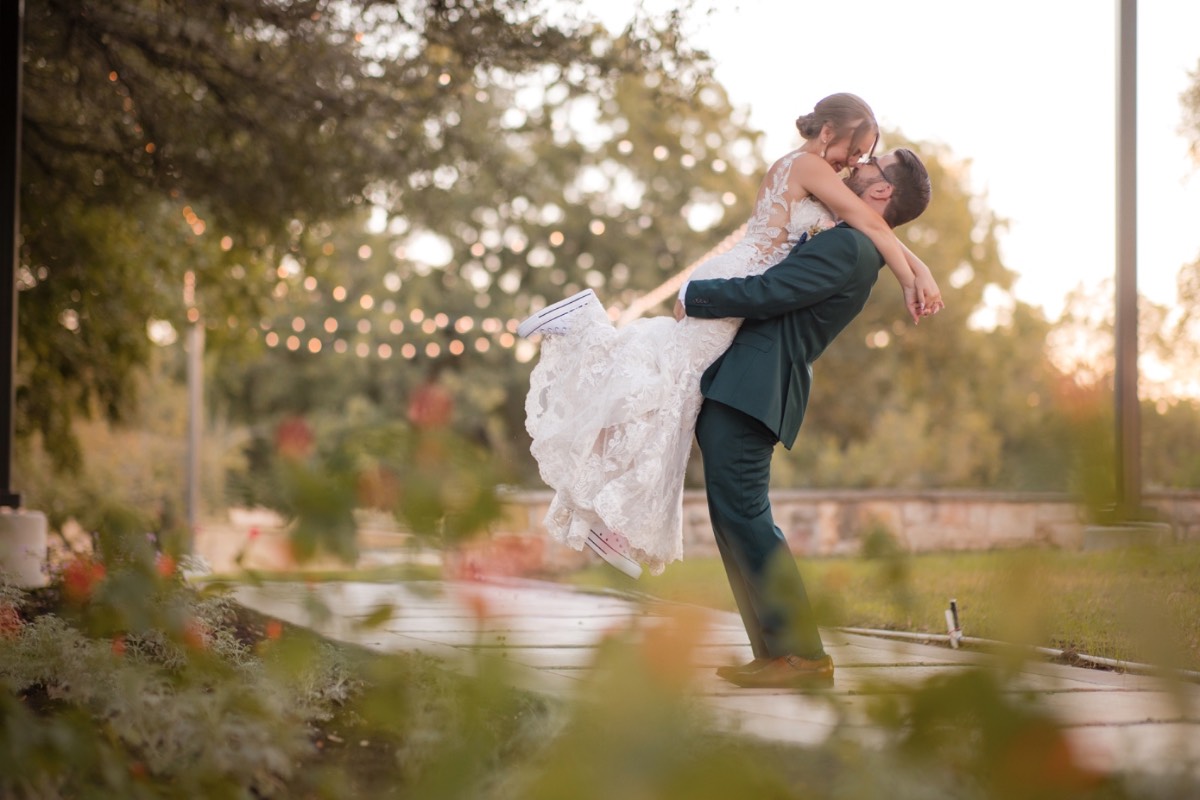 Bride and groom silhouetted against Garey House Georgetown during golden hour