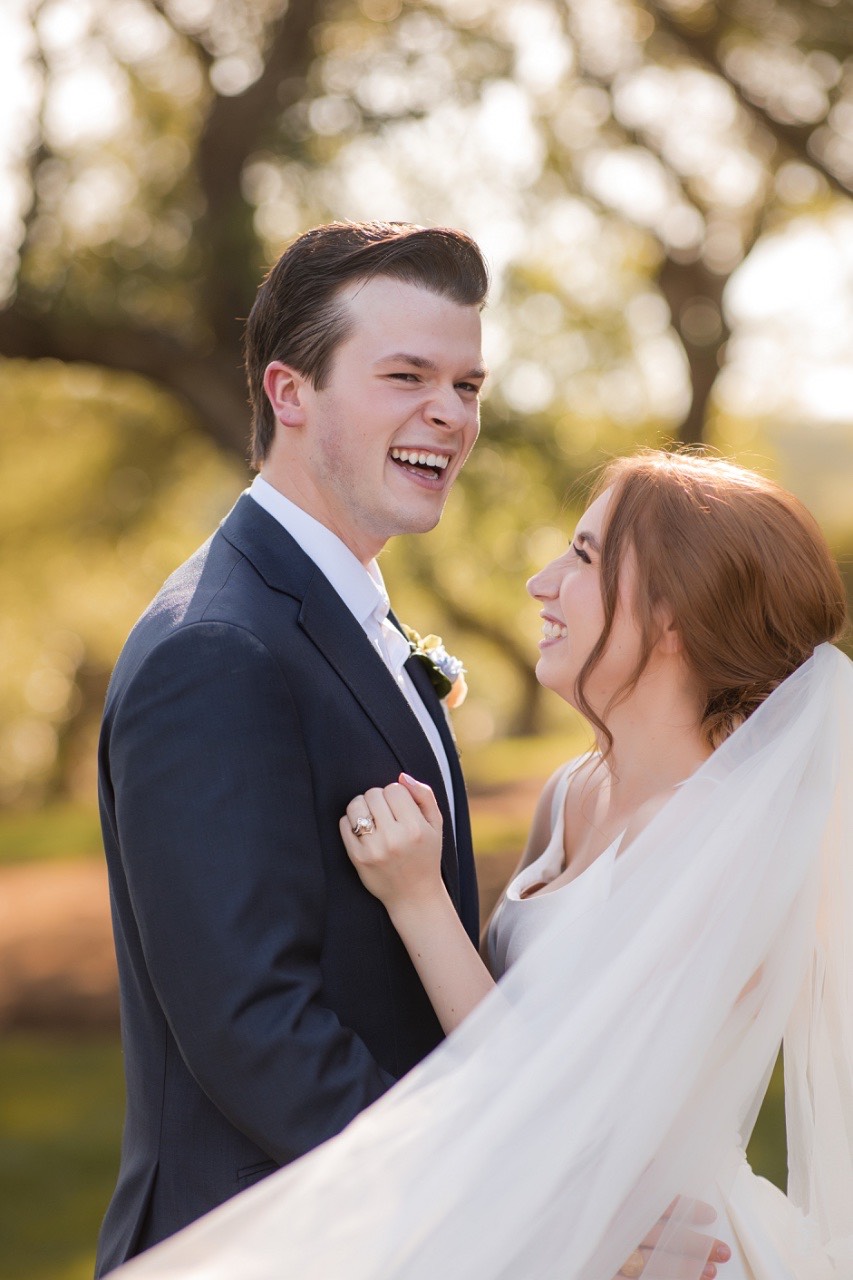 Bride O and groom C romantic kiss captured at Canyonwood Ridge wedding