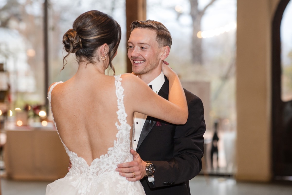 Emotional moment between couple during rainy Barr Mansion wedding.