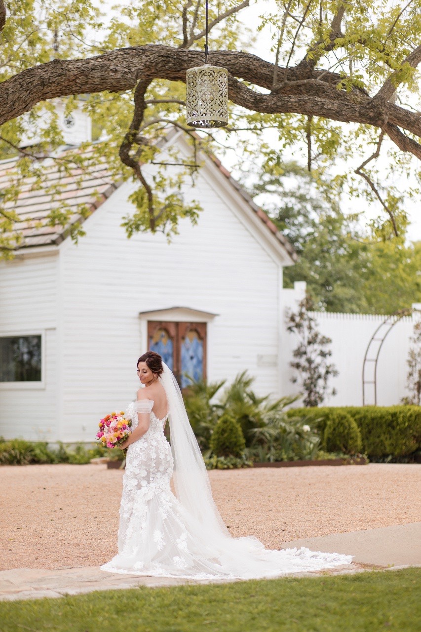 Bride L's dress train visible during first look at Barr Mansion
