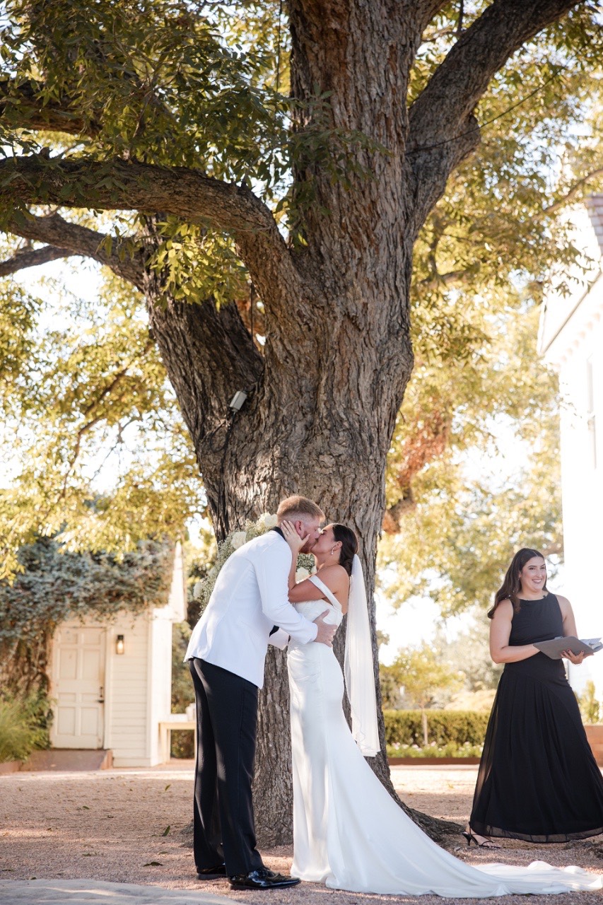 Newlyweds walking back down aisle at fall Barr Mansion wedding in Austin