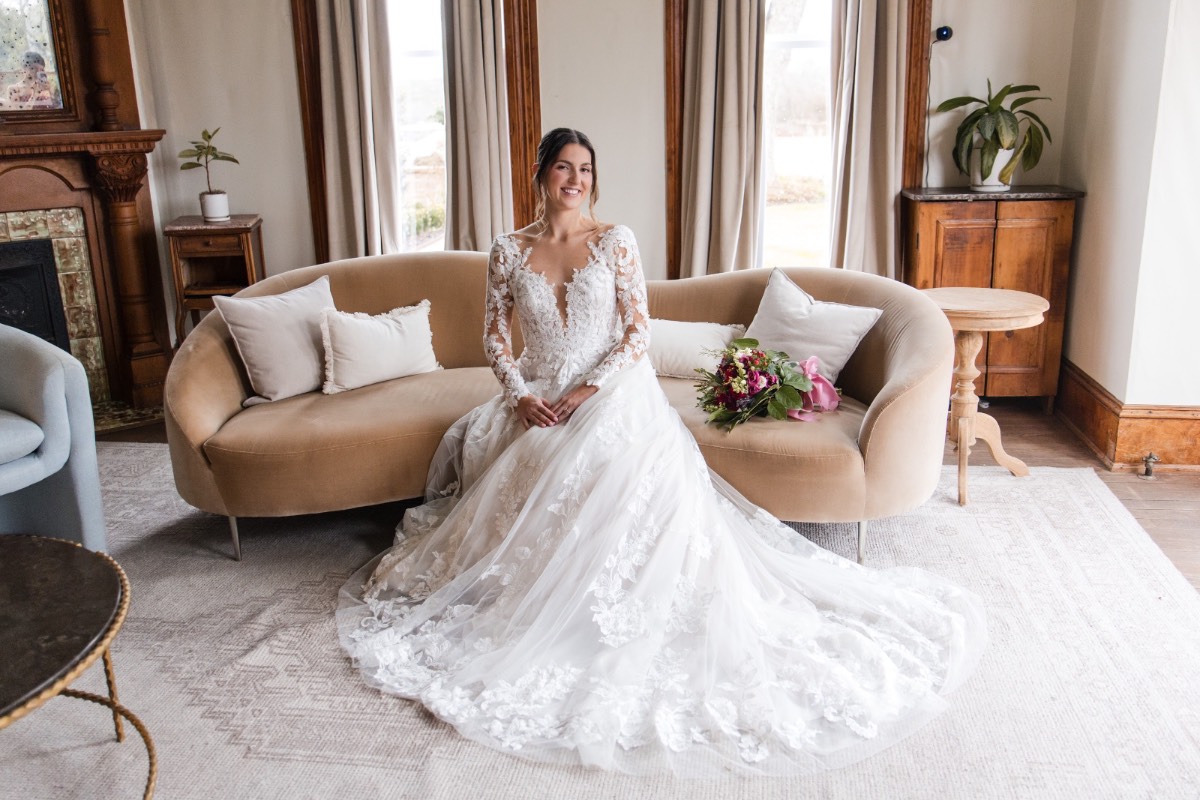 Bridal party assisting bride with dress at Barr Mansion Austin Texas.