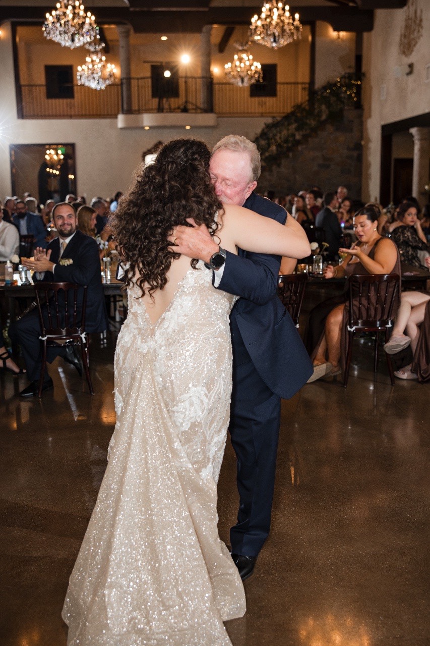 Bride twirling dress during playful moment captured at Dripping Springs venue