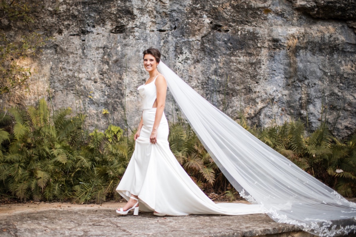 Bride and groom's walking portrait at The Retreat at Balcones Springs venue