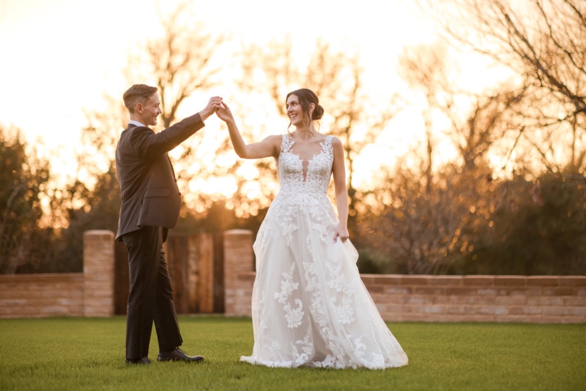 Wedding rings visible during ceremony at rainy Barr Mansion.