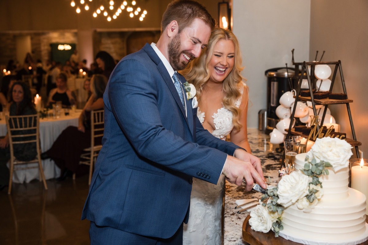 Couple's romantic kiss captured at Canyonwood Ridge winter outdoor wedding