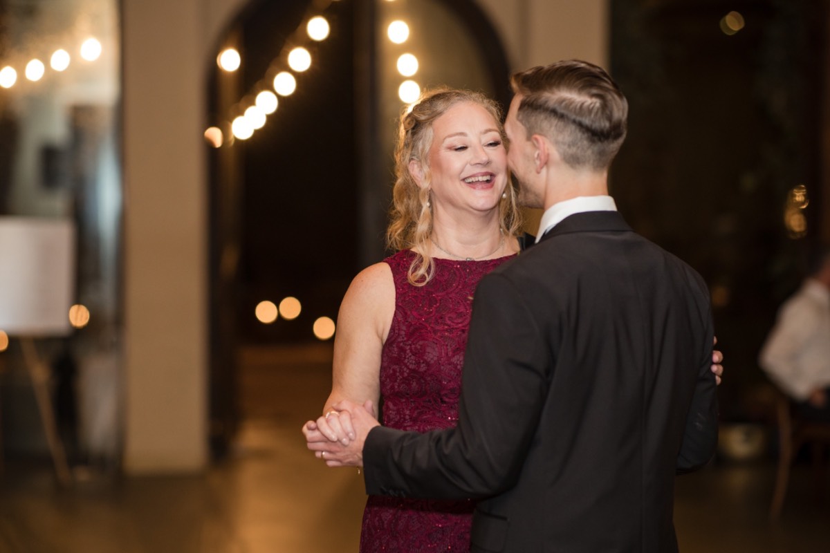 Bride and groom departing ceremony area at rainy Barr Mansion Austin.