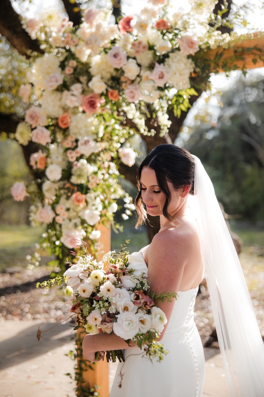 K's hair and makeup artist working on bride's look before ceremony