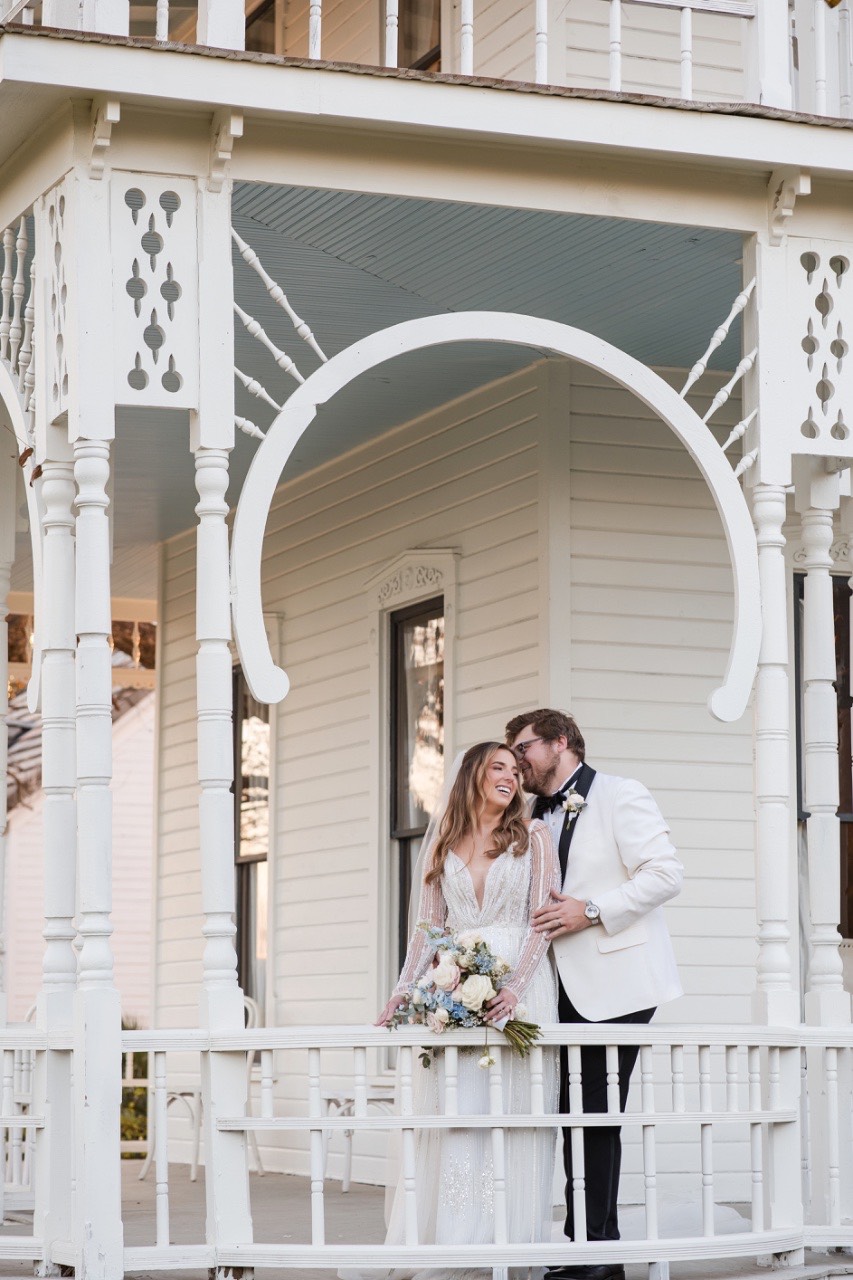 Bride and groom portrait with Barr Mansion's grand staircase in background.