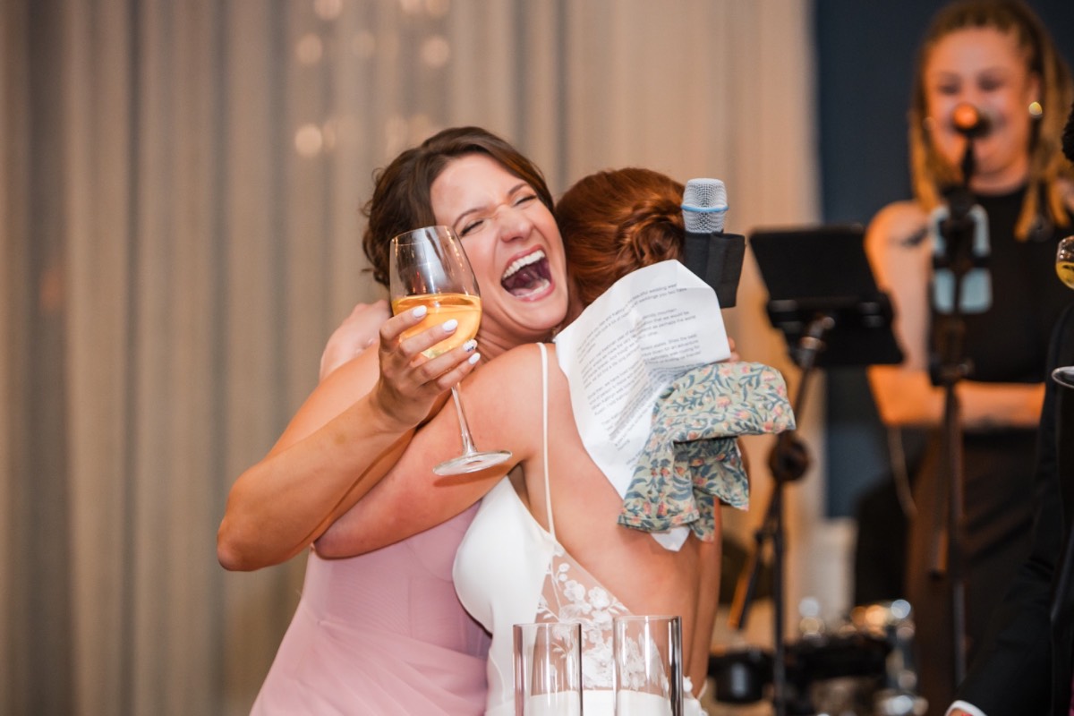 Bride with bridesmaids smiling at Hotel Ella Austin