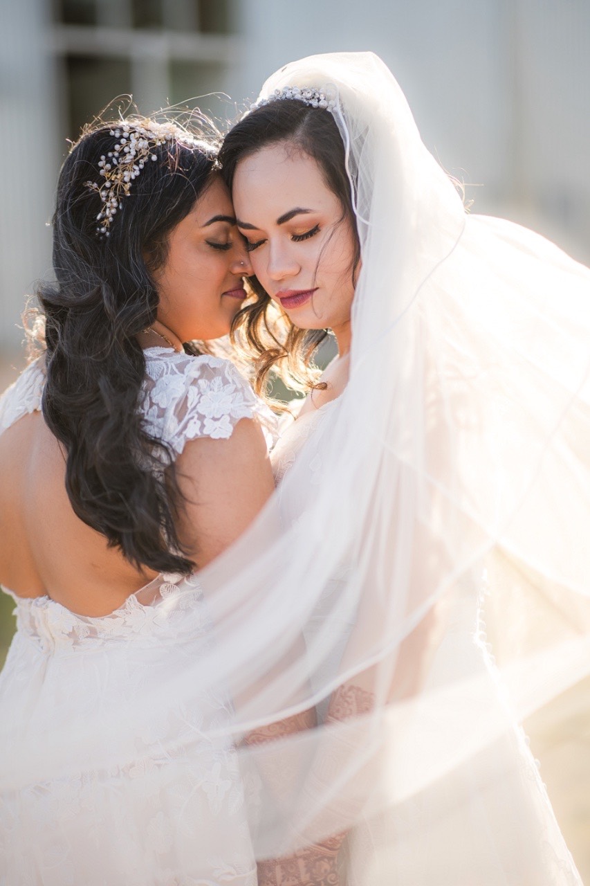 two brides embracing at their lgbtq wedding in Austin tx at prospect house
