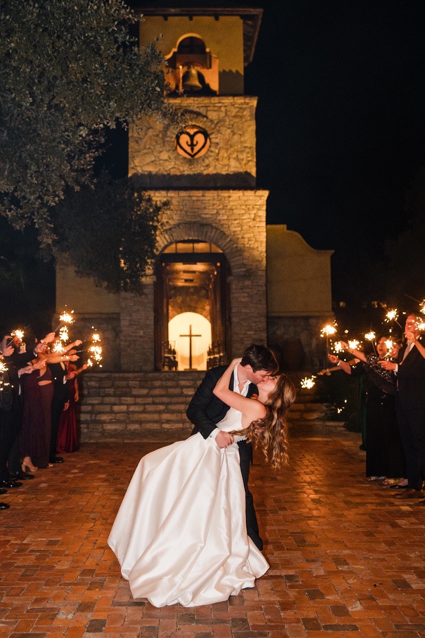 Couple's exit from Camp Lucy with guests holding sparklers wedding night