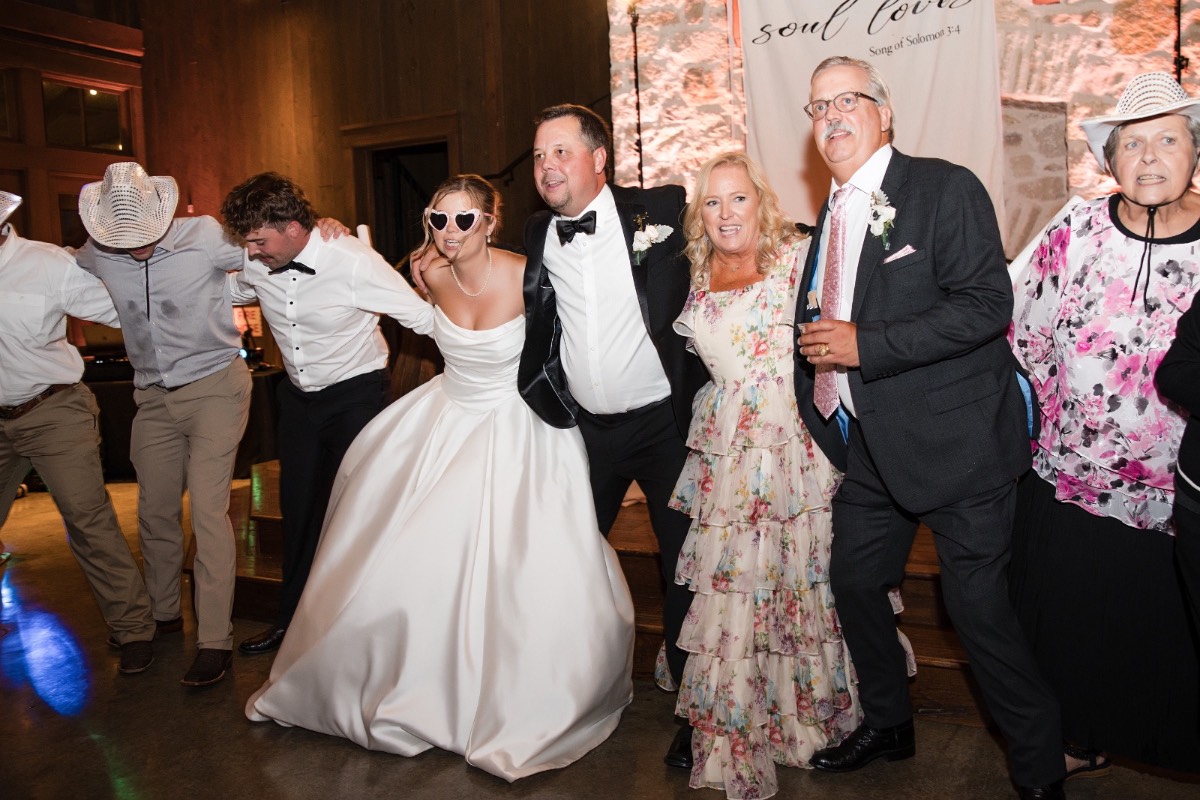 Bride and groom swaying to song during first dance at Hidden River Ranch