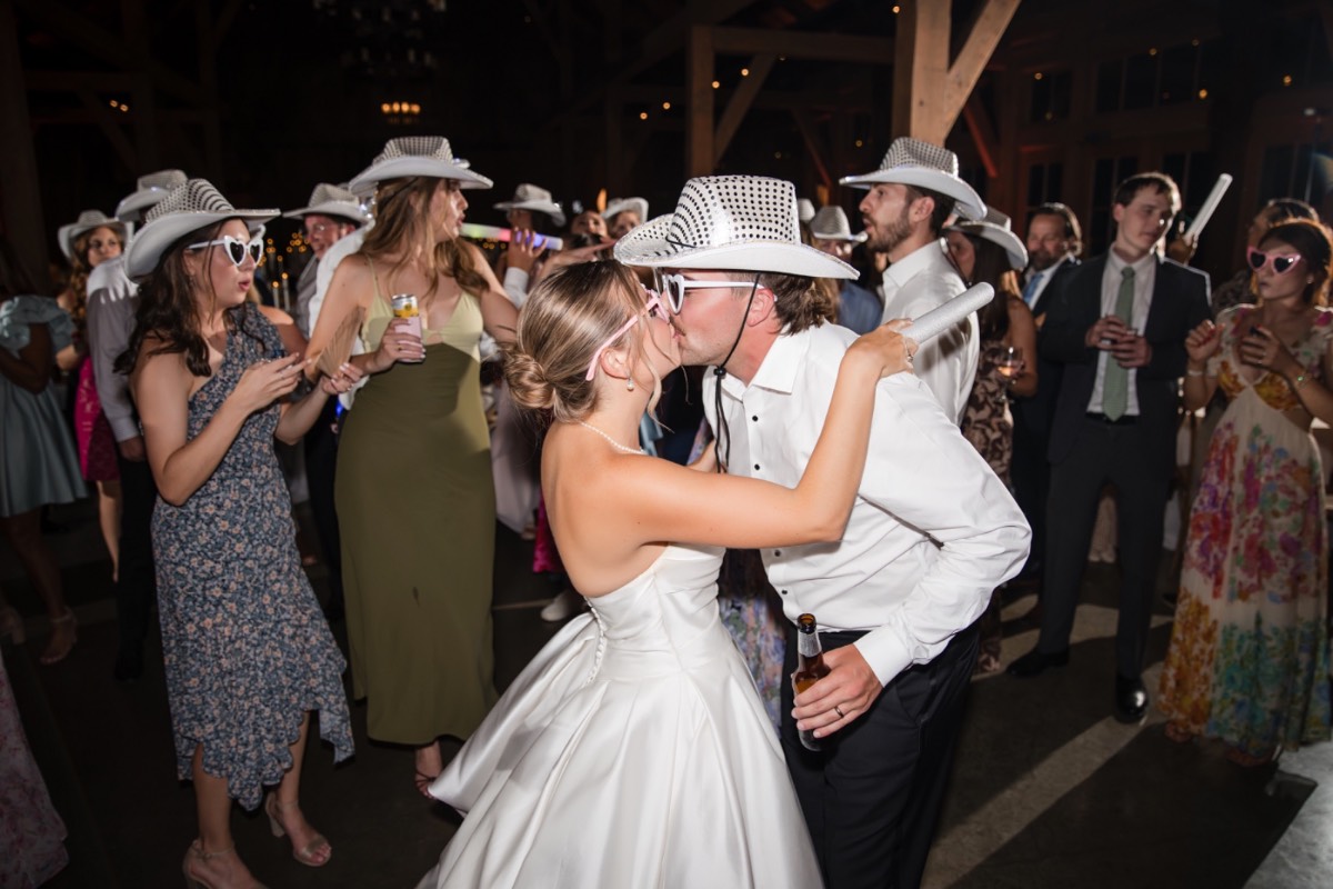 Newlyweds P and B dancing under lights at Hidden River Ranch reception