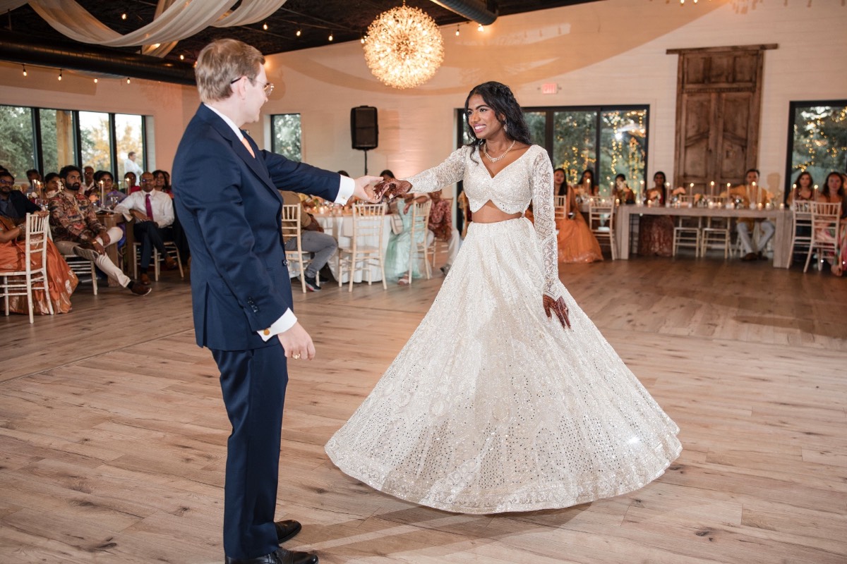 Bride mingling with guests during cocktail hour at Spicewood ranch