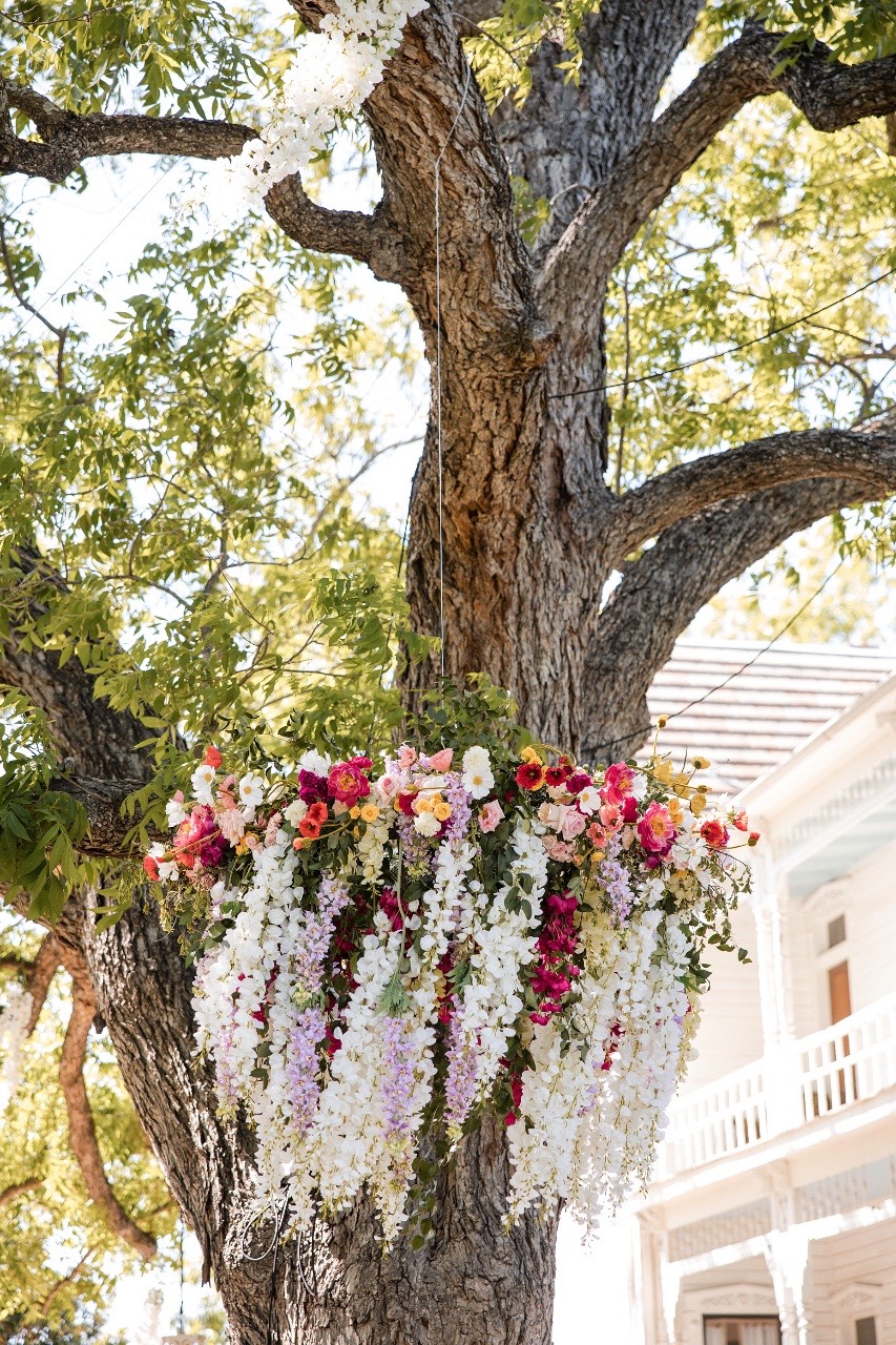 Guests throwing rose petals on bride L and groom S at Barr Mansion