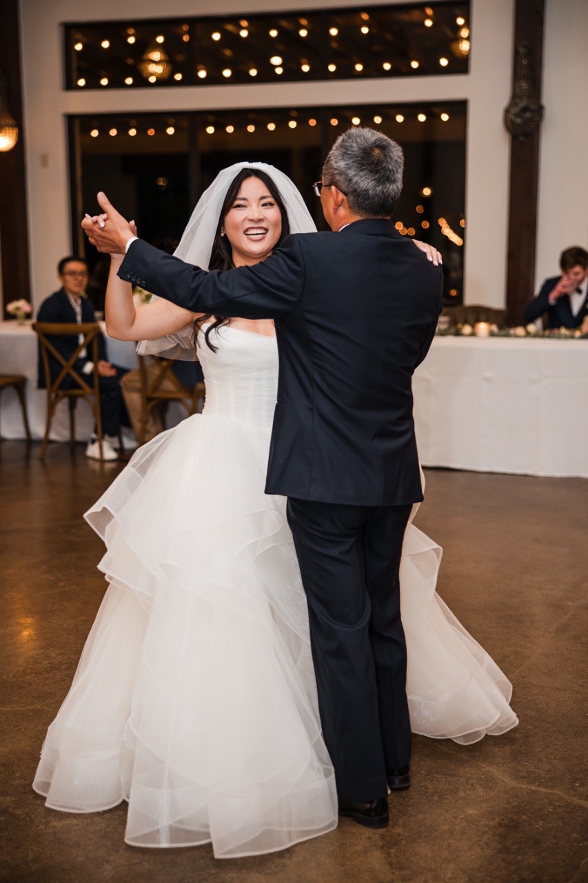 Best man toasting couple L and M at Pecan Springs Ranch reception