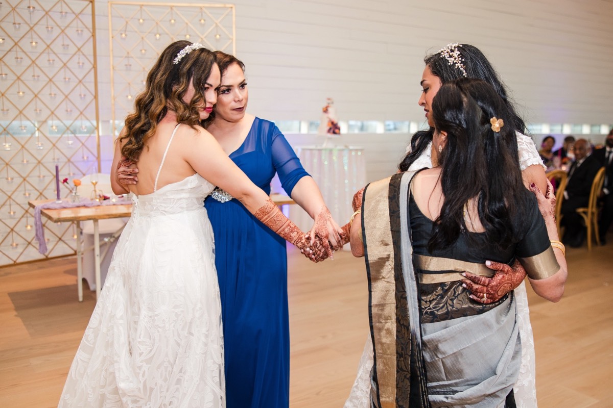 Bride A feeds groom D cake at Prospect House Texas wedding