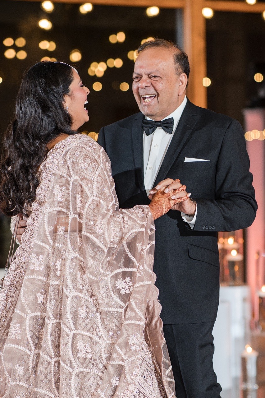 Bride dancing with father at Indian wedding reception
