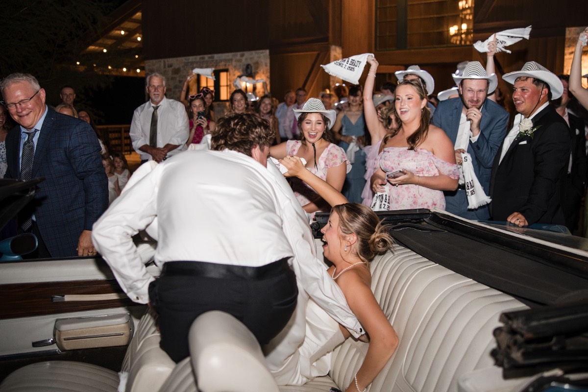 Guests clapping as couple shares cake together at Hidden River Ranch