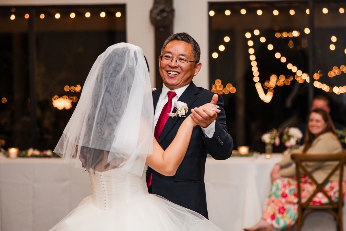 Wedding guests laughing during toasts at L and M's Pecan Springs Ranch wedding
