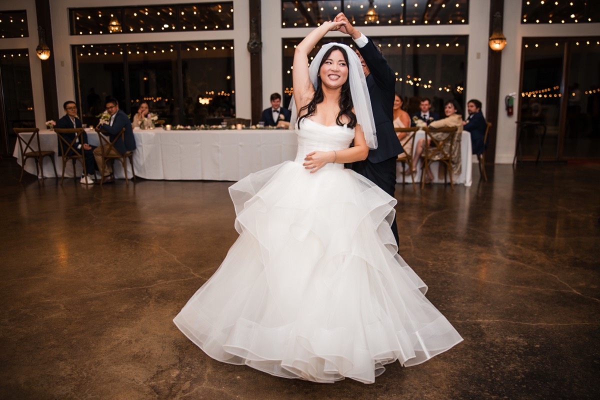 Bride L and groom M laughing during wedding speeches at Pecan Springs Ranch