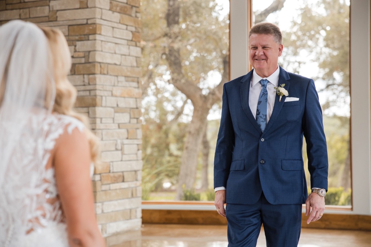 M fastening cufflinks before first look at Canyonwood Ridge Texas wedding