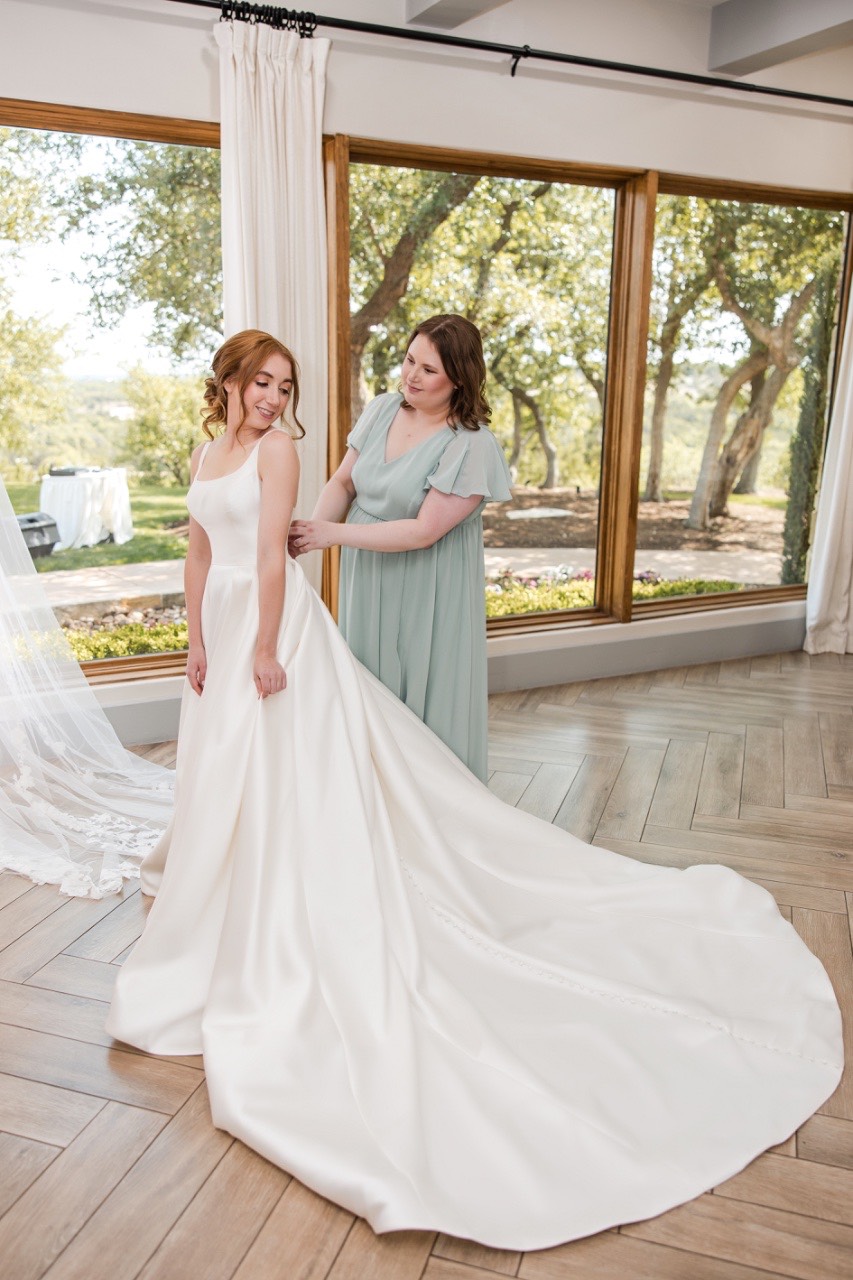 Groom C suits up for his Canyonwood Ridge Dripping Springs outdoor wedding ceremony