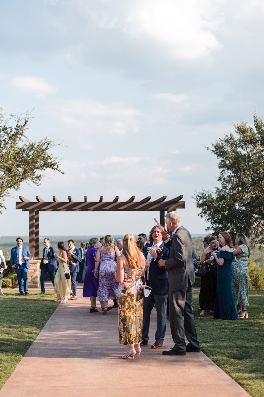 Candid dancing photo of guests at A and M's Canyonwood Ridge wedding reception